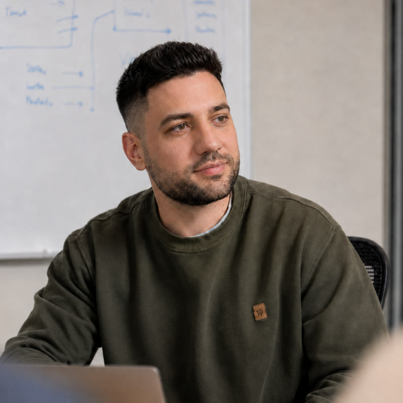 Bobby, founder of Rocket Fuel Reviews, at a whiteboard mapping out a client's growth plan